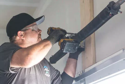 Garage door technician repairing a garage door