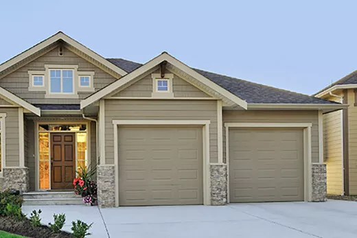 Beige house with 2 garage doors