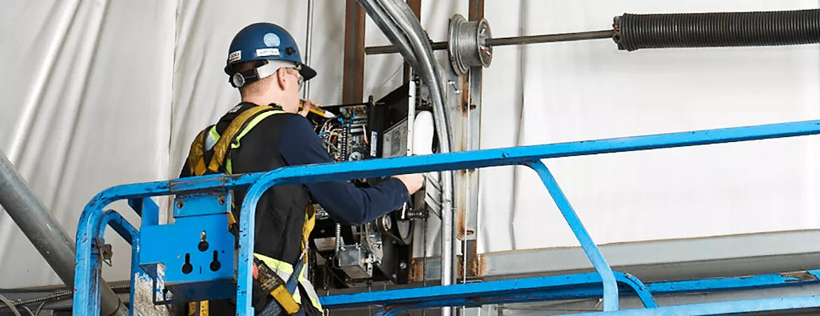 A Garage door specialist doing repairs
